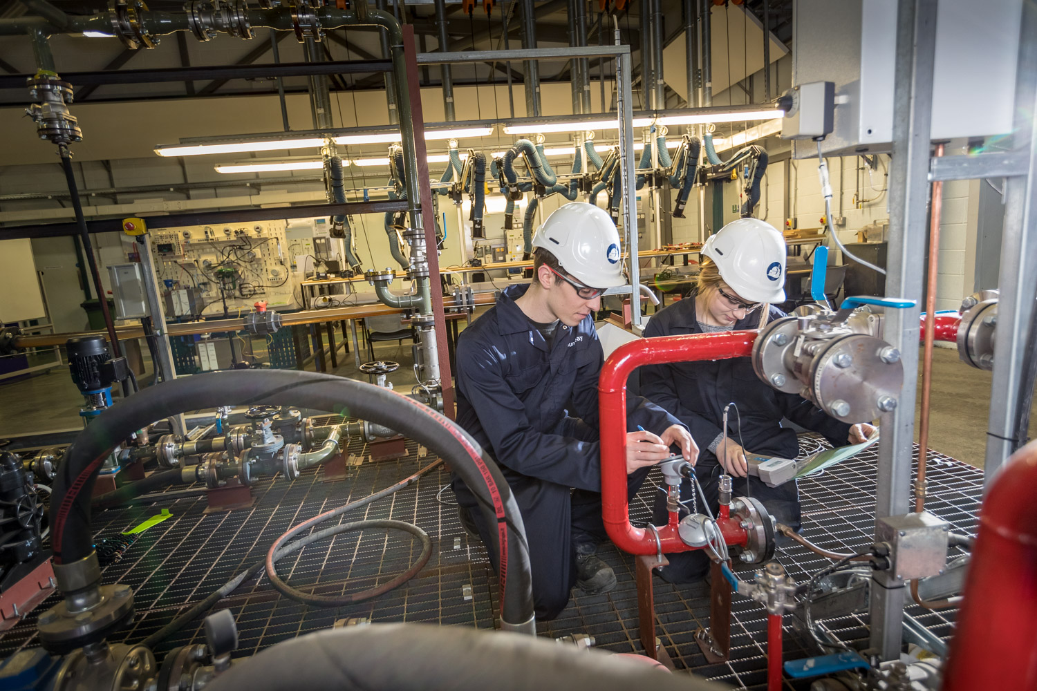 College students working on pipework monitoring